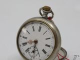 a silver pocket watch with roman numerals on it