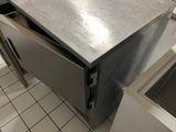 a stainless steel counter top in a kitchen with a sink