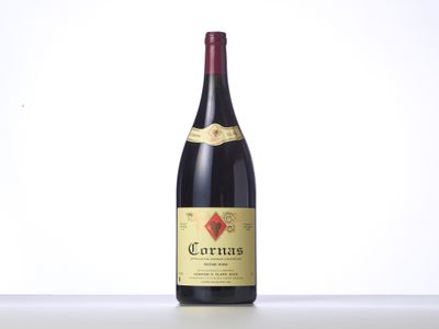a bottle of red wine sitting on top of a table
