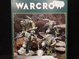 the box of warcro miniatures is sitting on a black surface