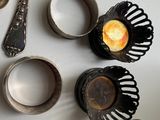 a table with silver spoons, cups and spoons on it