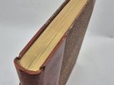 a close up of a book on a white surface with a white background