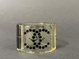 a close up of a ring with black dots on it