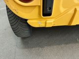 a close up of the rear end of a yellow vehicle