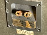 a close up of a metal box with two screws in it