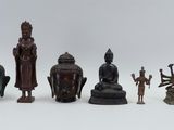 a lot of asian figurines sitting on a white surface