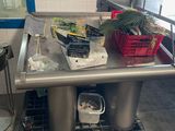 a table with a bunch of food on it in the kitchen