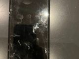 an iphone with a cracked screen sitting on top of a table