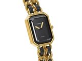 an image of a black and gold watch with a chain bracelet