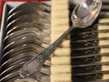 a box of silver spoons and spoons sitting on top of each other