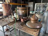 a large copper pot sitting on top of a wooden table
