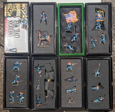 six boxed boxes of miniature figurines of soldiers and a flag