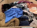 a cardboard box full of clothes in a warehouse