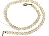 a close up of a white pearl necklace on a white background
