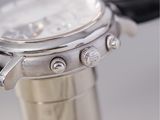 a close up of a silver watch on a table