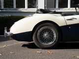 a white and blue car parked in front of a building