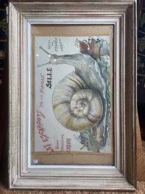 painting of a snail on a table in a frame on a table