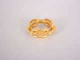 a close up of a gold ring on a white surface