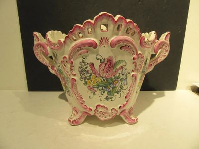 a pink and white bowl with a floral design on it