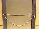 an old picture frame with a rope hanging from it ' s side