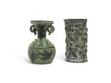 two vases sitting next to each other on a white surface