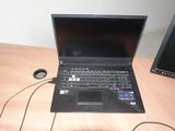 a laptop computer sitting on a desk next to a monitor
