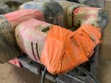 an orange bag sitting on top of a couch in a room