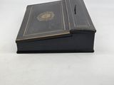 a black box with gold trim and a black cover