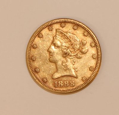 a close up of a gold coin with a woman ' s head on it