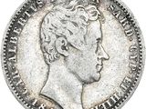 gros plan d'une pièce de monnaie sur laquelle figure une tête d'homme