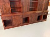 a very large wooden cabinet with many shelves and doors