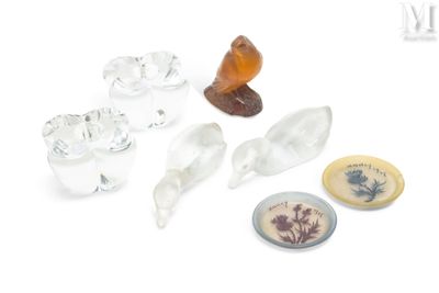 a small collection of glass objects on a white surface