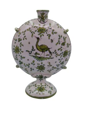 a vase with a bird on it sitting on a stand