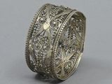 a close up of a silver ring on a gray surface