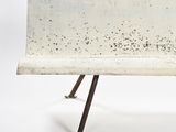 a white bench with black spots on it on a white background