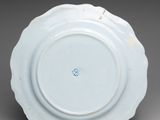 blue and white plate with a flower decoration on the rim