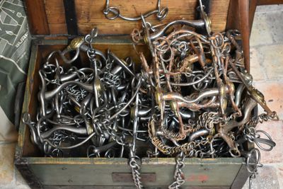 a wooden chest filled with lots of chains and hooks