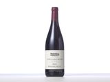 a bottle of red wine sitting on top of a table