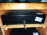 a black metal box with a key on top of it