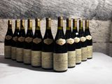 several bottles of wine are lined up in a row on a table
