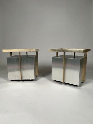 a pair of stainless steel and wood side tables