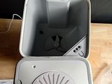 a white box with a fan inside of it