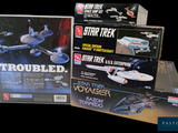 several star trek toys are stacked on top of each other