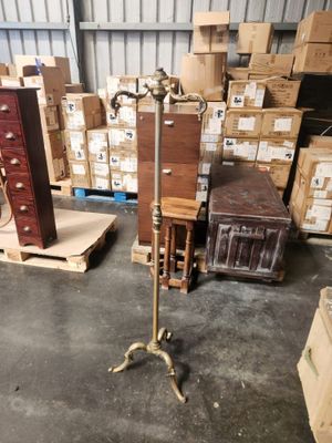 a floor lamp that is on a stand in front of boxes
