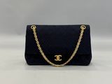 a chanel black quilted bag with gold hardware and chain