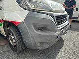 a man standing next to a van that has been vandalized