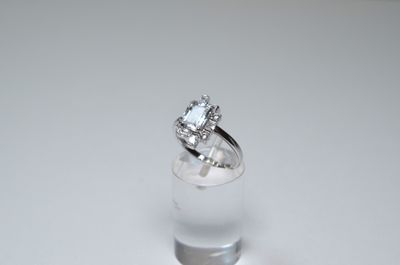 a diamond ring sitting on top of a glass of water