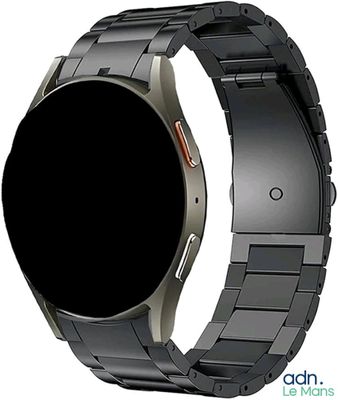 a close up of a metal bracelet with a black watch face