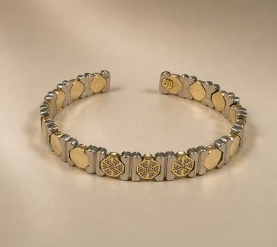 a close up of a bracelet on a white surface