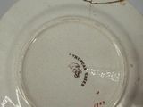 a white plate with a design on it on a table